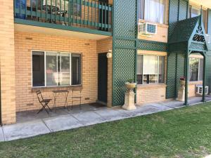a building with a table and chairs on a patio at Stay in spacious, homely unit in prestigious area in Broadview