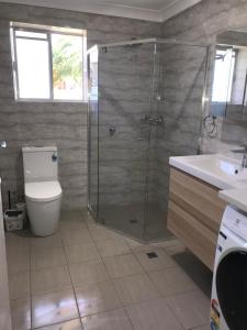 a bathroom with a shower and a toilet and a sink at Stay in spacious, homely unit in prestigious area in Broadview