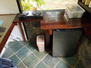 a desk and a trash can under a table at Gap Creek Cabin in Ayton