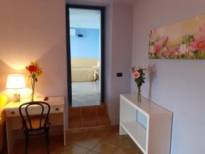 a room with a desk and a chair and a mirror at Luna Convento Copanello B&B in Stalettì