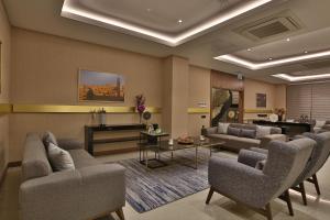 a living room with couches and chairs and a table at Mardin Airport hotel in Mardin