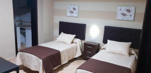 Łóżko lub łóżka w pokoju w obiekcie Hostal Málaga