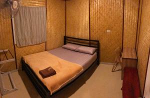 a small bedroom with a bed in a room at Rock View Terrace in Ko Jum