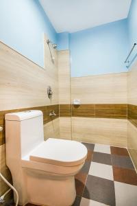 a bathroom with a toilet and a glass shower at Casa Bonita Inn Oslob in Oslob