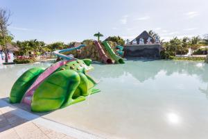a green and yellow pool with a green umbrella at Grand Palladium Colonial Resort & Spa - All Inclusive in Akumal