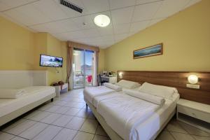 Postel nebo postele na pokoji v ubytování Hotel Residence Zust