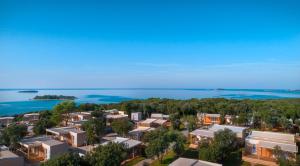 a large body of water with houses and trees at Mobile Homes Veštar in Rovinj