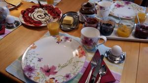 a wooden table with plates and glasses of orange juice at B & B Gästehaus Schmidt in Lichtenberg
