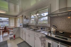 a kitchen with a sink and a stove at Hale Ulu Kealoha in Hilo