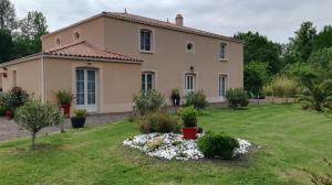 una casa con un jardín delante de ella en Le logis du marais, en Les Magnils-Reigniers