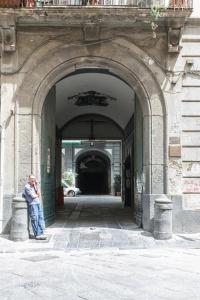 a man standing in an archway in a building at Jungle Suite in Naples