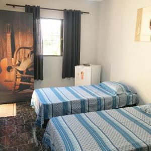 Un pat sau paturi într-o cameră la Lodge Hostel Piracicaba