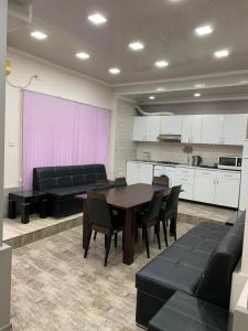 a room with a table and chairs and a kitchen at Nizami street floor 1 in Baku
