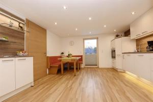 a kitchen and dining room with a table in a room at Appartement Moni in Sankt Gallenkirch