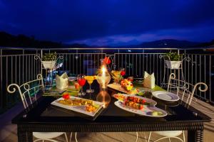 a table with food and drinks on a balcony at Sterling Thekkady in Thekkady