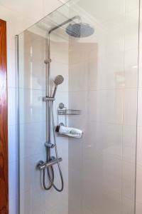een douche met een douchekop in de badkamer bij Playa Flamenca Casa 88 in Playa Flamenca