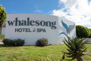a sign for a whalersong hotel and spa at Whalesong Hotel & Spa in Plettenberg Bay