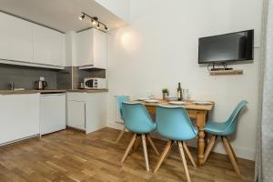 a kitchen and dining room with a table and chairs at Apartment Iris 4 in Chamonix-Mont-Blanc