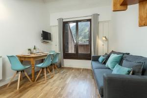 a living room with a blue couch and a table at Apartment Iris 4 in Chamonix-Mont-Blanc