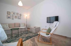 a living room with a couch and a tv at Laconian Collection #Othonos luxury apartment# in Sparti
