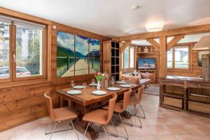 a dining room with a table and chairs at Edelweiss apartment - Chamonix All Year in Chamonix