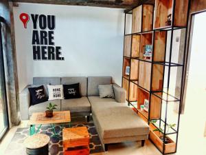 a living room with a couch and a book shelf at Happy House BnB Bromo backpacker in Probolinggo