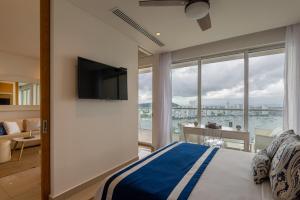 a bedroom with a bed and a view of the ocean at Classy 1 BR, Pool, Gym near Downtown Cartagena by Huespedia in Cartagena de Indias