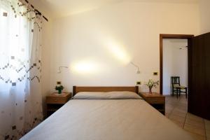 Postel nebo postele na pokoji v ubytování Villa Dei Pini