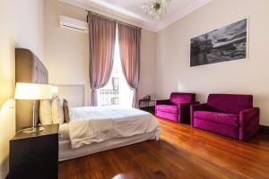 Posteľ alebo postele v izbe v ubytovaní Gramsci Suites