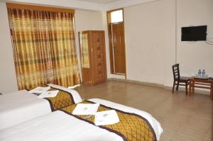 Postel nebo postele na pokoji v ubytování Mekelle Hotel