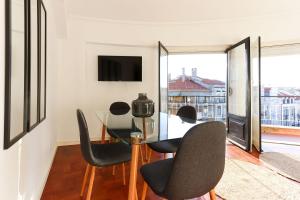 a dining room with a table and chairs at Marques Balcony by Homing in Lisbon