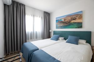 Łóżko lub łóżka w pokoju w obiekcie Bitacora Lanzarote Club
