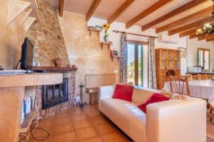a living room with a couch and a fireplace at Els Girasols Winter in Campos
