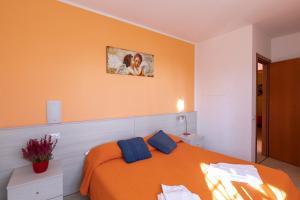 A bed or beds in a room at Residence La Collina