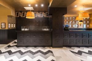 a bar in a restaurant with a checkered floor at Room Mate Collection Alba, Madrid in Madrid +51 photos