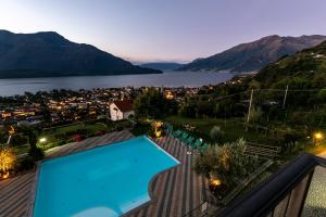 a swimming pool on a roof with a view of a lake at Residence La Collina in Vercana