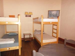 a room with three bunk beds and a table at Three Palms Fianar in Fianarantsoa