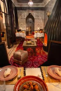 a dining room with a table with plates of food at Riad Touda in Marrakesh