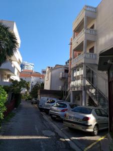a row of cars parked in front of a building at VILA MAKA in Budva