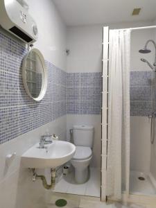 a bathroom with a sink and a toilet and a mirror at Málaga Centro Hostel in Málaga