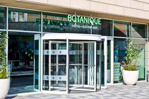 an entrance to a building with two revolving doors at Botanique Hotel Prague in Prague