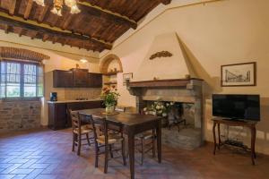 a kitchen with a table and a fireplace at Il Gelso in Cortona