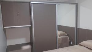 1 dormitorio con armario de cristal y cama en RIO QUENTE PARK VEREDAS Flat, en Rio Quente 32 fotos más