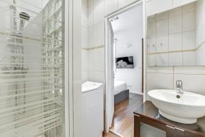 a white bathroom with a sink and a mirror at Pick A Flat's Apartments in Batignolles - Rue Biot in Paris