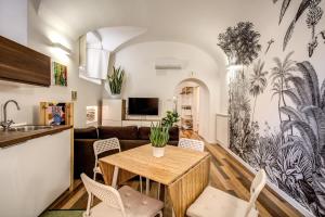 a kitchen and living room with a table and chairs at FRESH HOUSE NAVONA in Rome