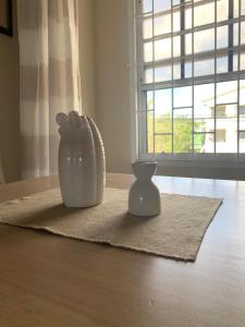 two vases sitting on a table with a window at Beach Vue Barbados in Bridgetown +35 photos