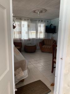 a living room with a couch and a television at Beach Vue Barbados in Bridgetown