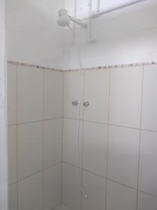 La salle de bains est pourvue d'une douche avec un pommeau de douche. dans l'établissement Loft Aconchegante, à São Bento do Sapucaí