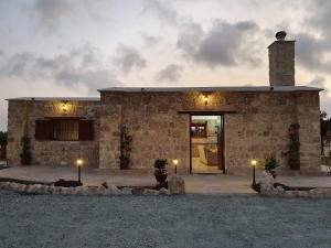 a stone house with lights in front of it at Villa Yioukkas in Paphos City