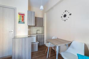 a kitchen with a table and chairs in a room at Cosy studio 1 in Stoupa in Stoupa +18 photos